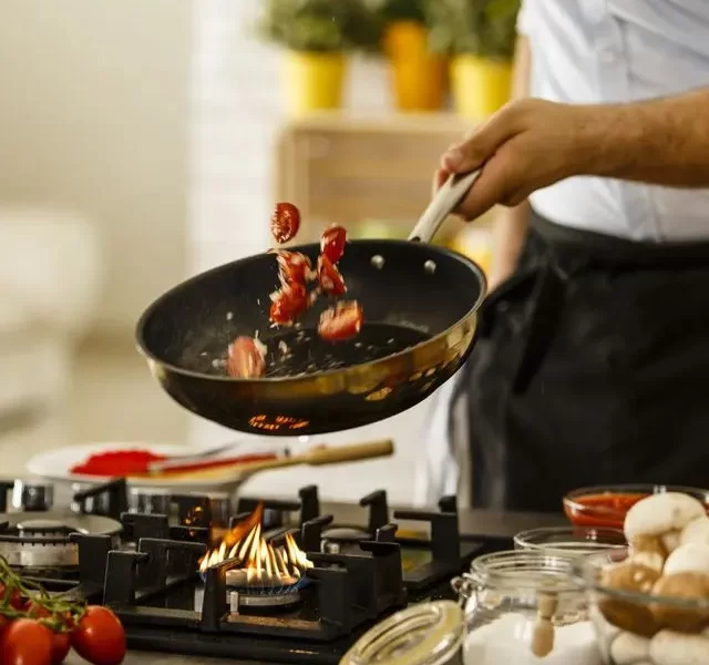 chef using tri-ply stainless steel cookware